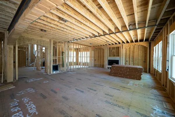 Open interior home framing with natural light