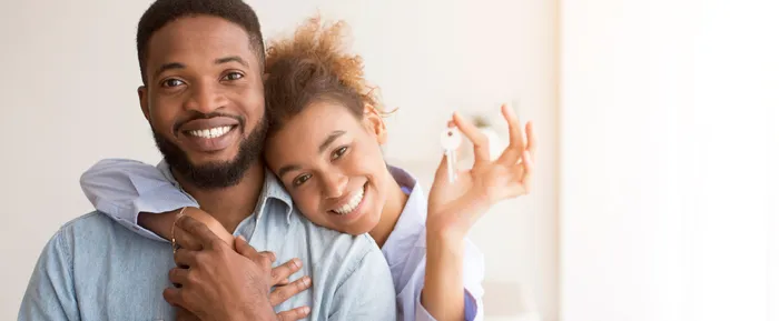 Happy couple holding keys to their new home
